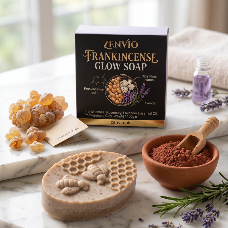 Zenvio Frankincense Glow Soap with Raw Herbal Ingredients Zenvio Frankincense Glow Soap bar with product packaging, raw frankincense resin, pomegranate clay, and fresh lavender on a marble surface.